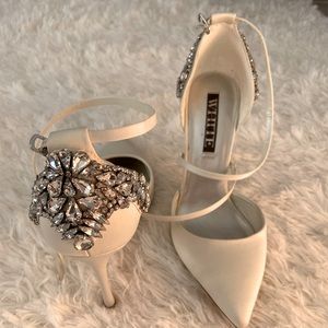 White satin and rhinestone heels.